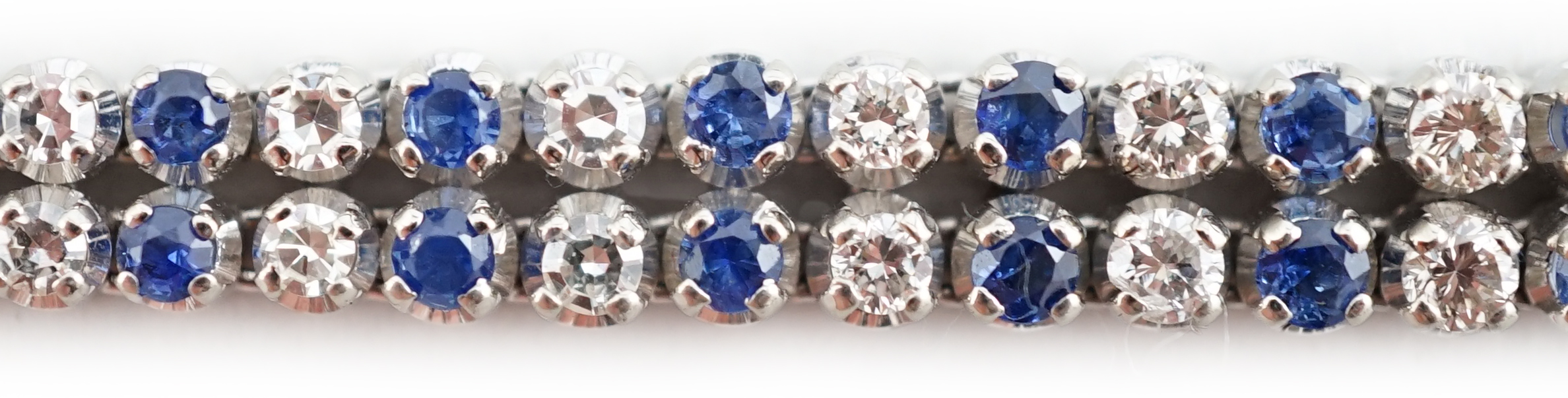 A 1960's 14ct white gold, sapphire and diamond two row line bracelet